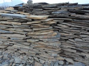 Naturally rusted slate stone is used for paving roads in random random crazy paving stones